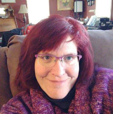 Profile picture: smiling person with glasses and short hair